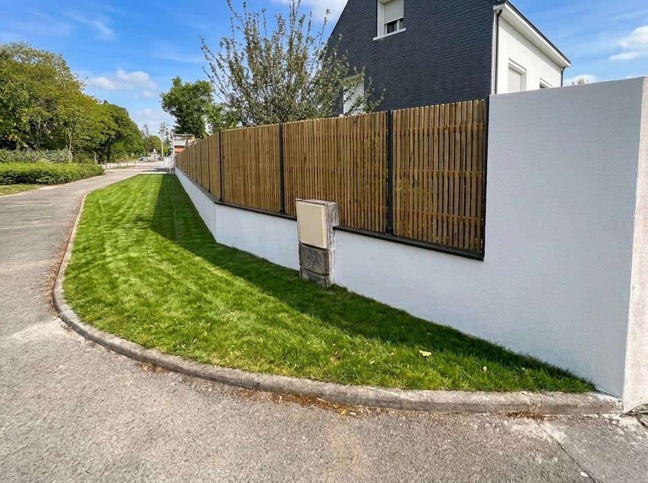 Terrasse extérieure en dalles de pierre naturelle type ardoise ou schiste bleu-gris, posées en appareillage décalé